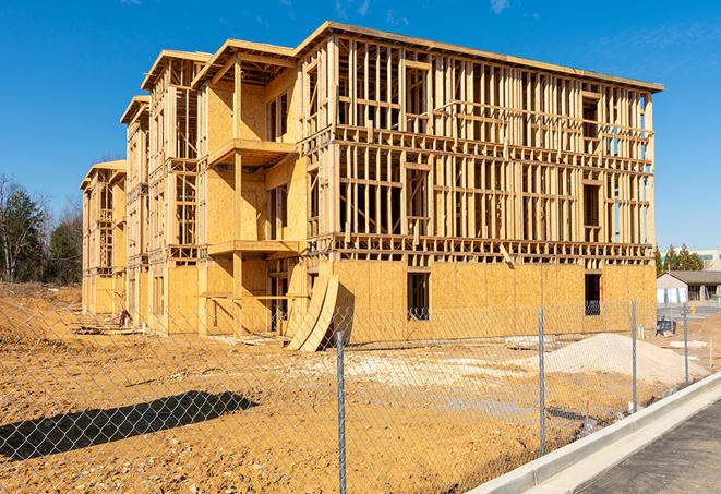 construction zone secured with a temporary fence, marked with warning signs in Montebello, CA